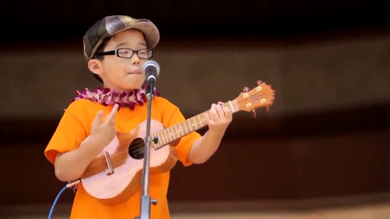 Kid with ukulele on stage