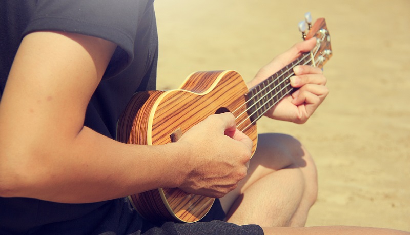 Playing Ukulele on a Beach