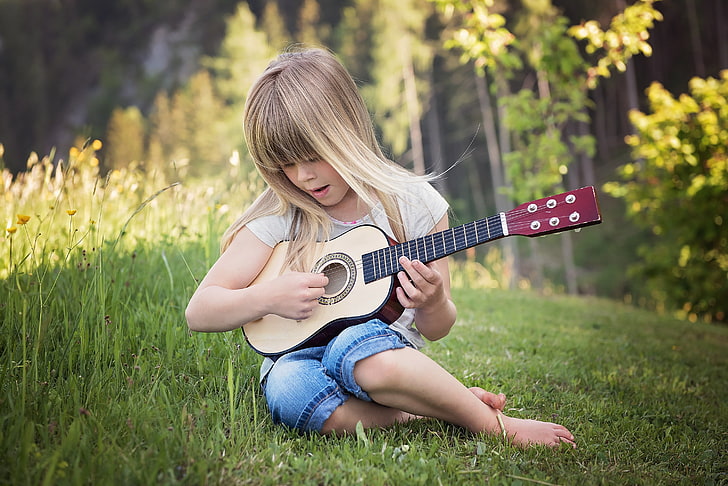Kid on a small guitar