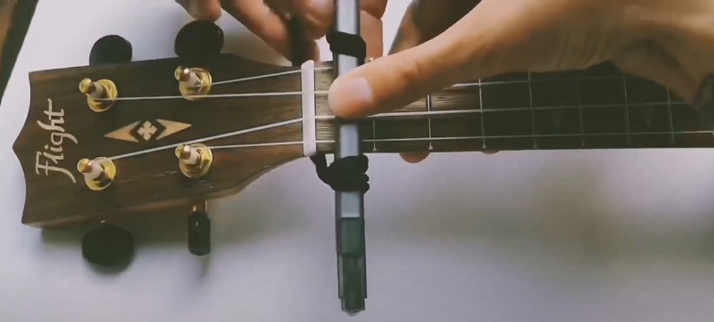 DIY capo for ukulele adding on the fretboard step 2