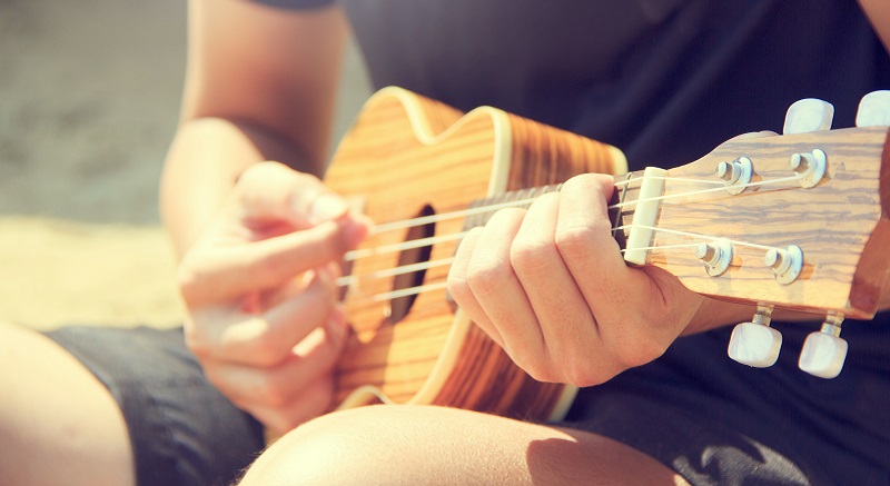 strumming a ukulele