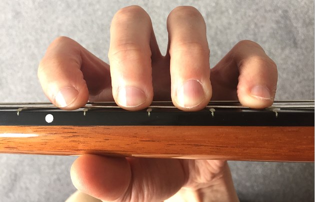 lying fingers on fretboard