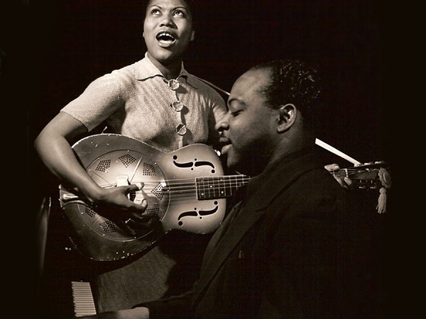 a black girl playing on resonator guitar