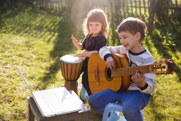 boy a girl playing on musical instruments