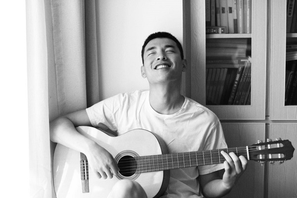 a boy playing on a guitar