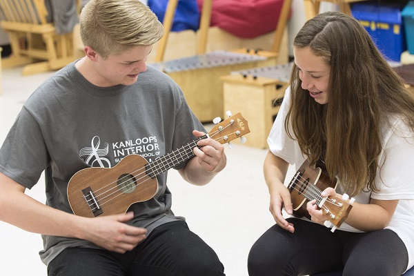 boy and girl playing on a strings instruments