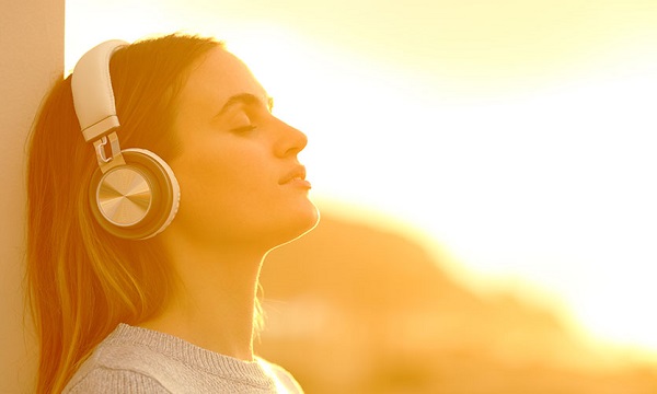 girl listening to the music - why you should learn a musical instrument
